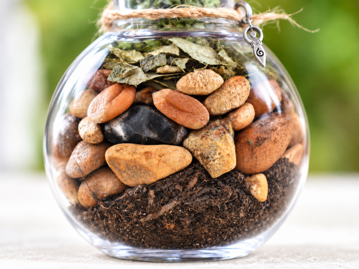 Close-up detail of a handcrafted Yarrow Moon Offering Jar with natural textures and silver charm.