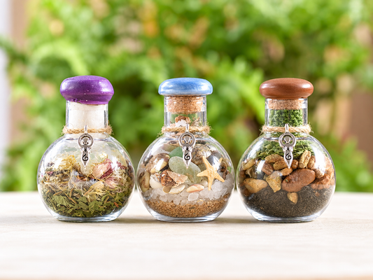 Three Yarrow Moon Offering Jars for Earth, Sky and Sea displayed together against greenery.