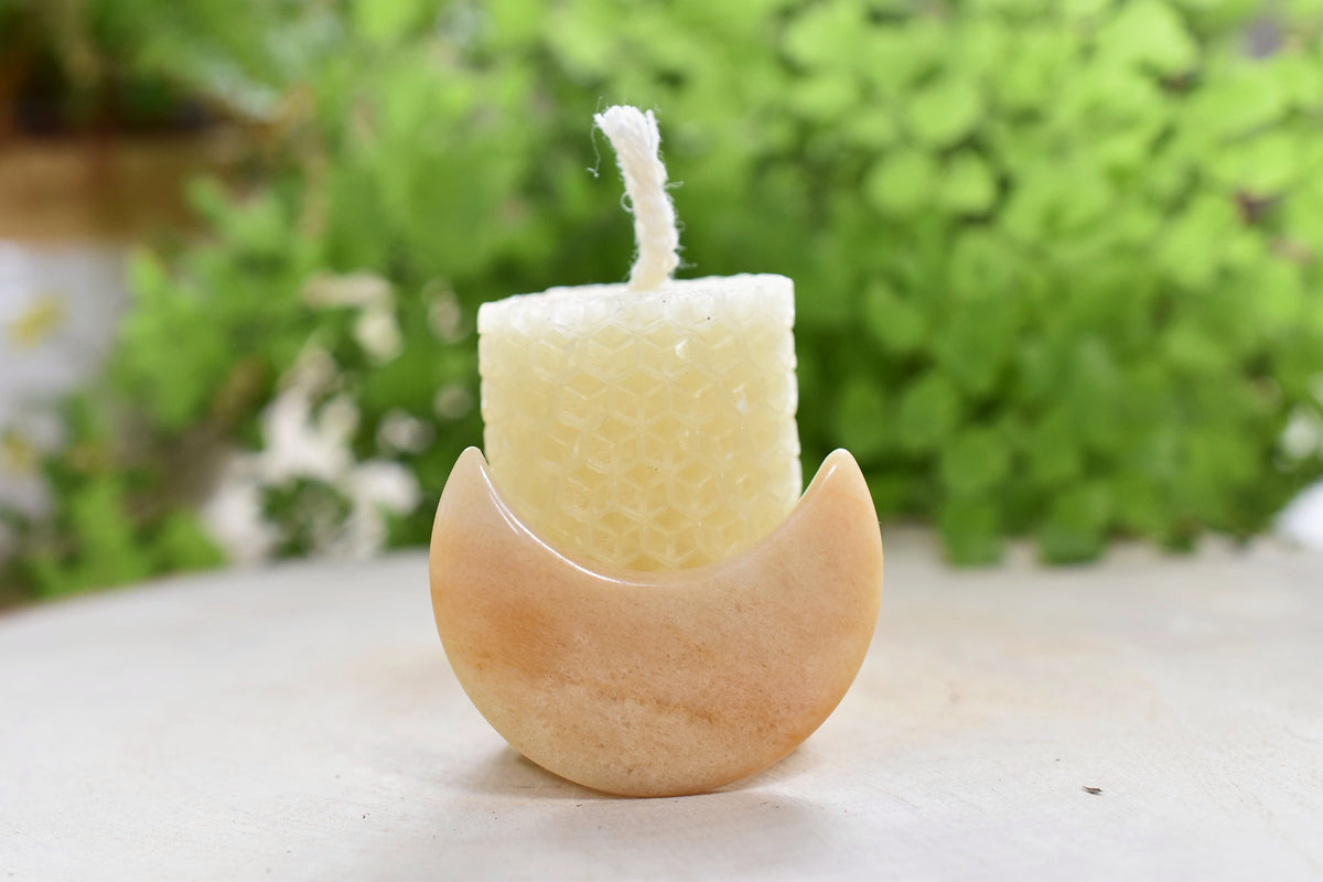 Sunwater beeswax candle and yellow aventurine crescent.