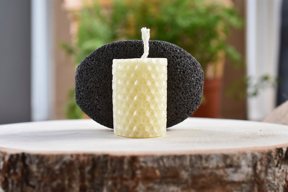Wellspring beeswax candle and natural pumice stone.