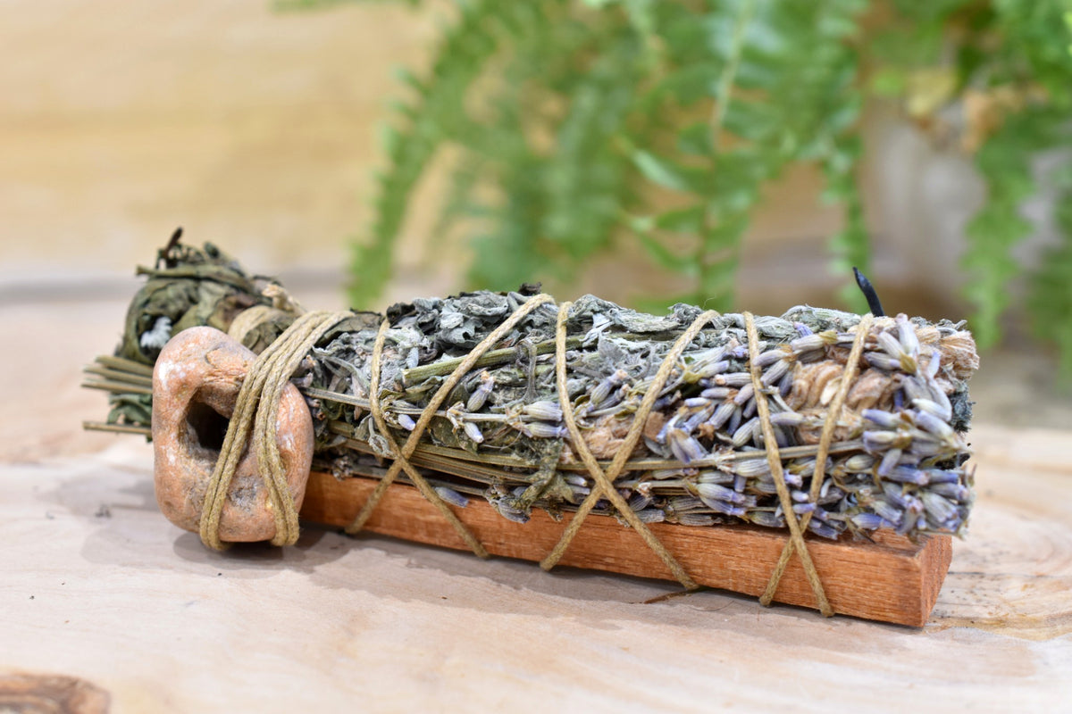 Guardian’s Wand detail showing hand-bound dried botanicals and hag stone