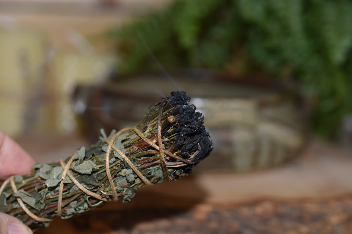 Joyful Purification Wand held in hand while smoke cleansing